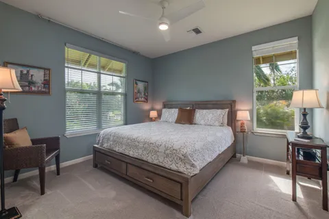 a bed sitting in a bedroom next to a window