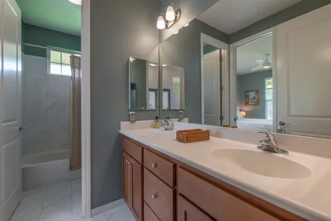 a bathroom with double vanity sinks and a mirror
