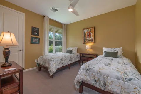 a bedroom with two beds and a window