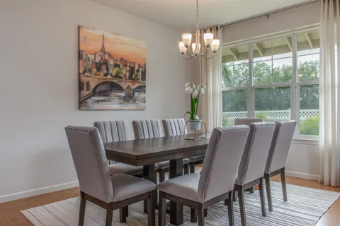 a view of a dining room with furniture window and wooden floor