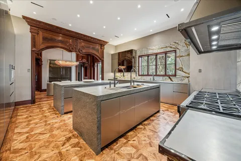 a kitchen with stainless steel appliances granite countertop a sink and a stove