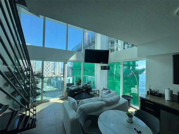 a living room with furniture and a large window