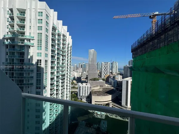 a view of balcony with two chairs and potted plants