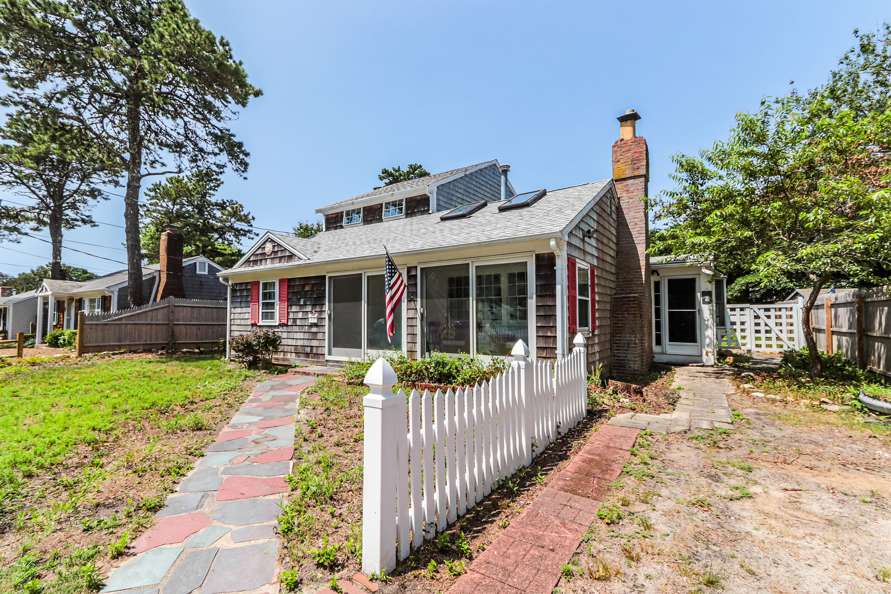 a front view of a house with a yard table and chairs