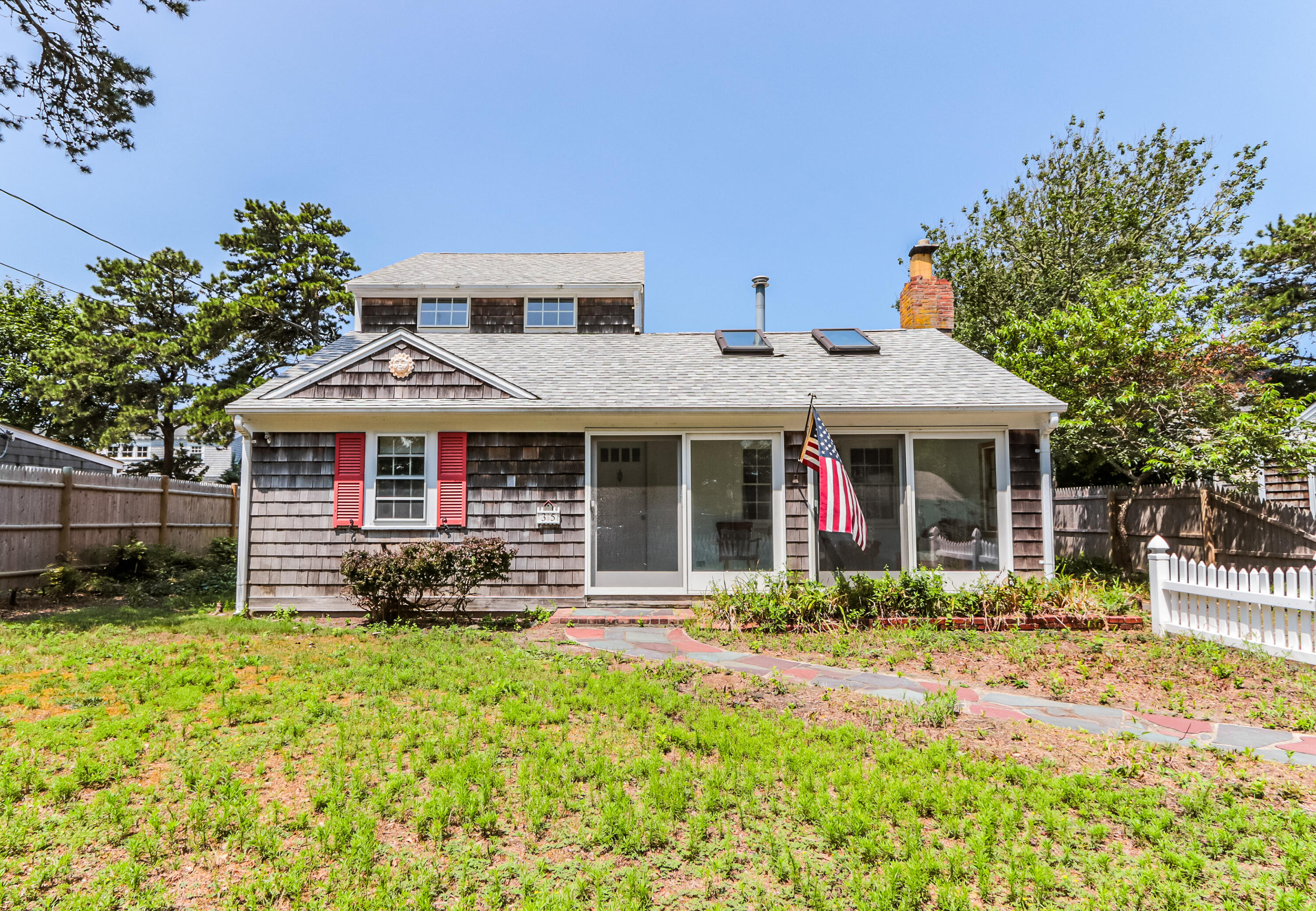 35 Susan Ruth Road Dennis Port, MA 02639 - Photo 2 of 23 a front view of a house with a porch and a yard