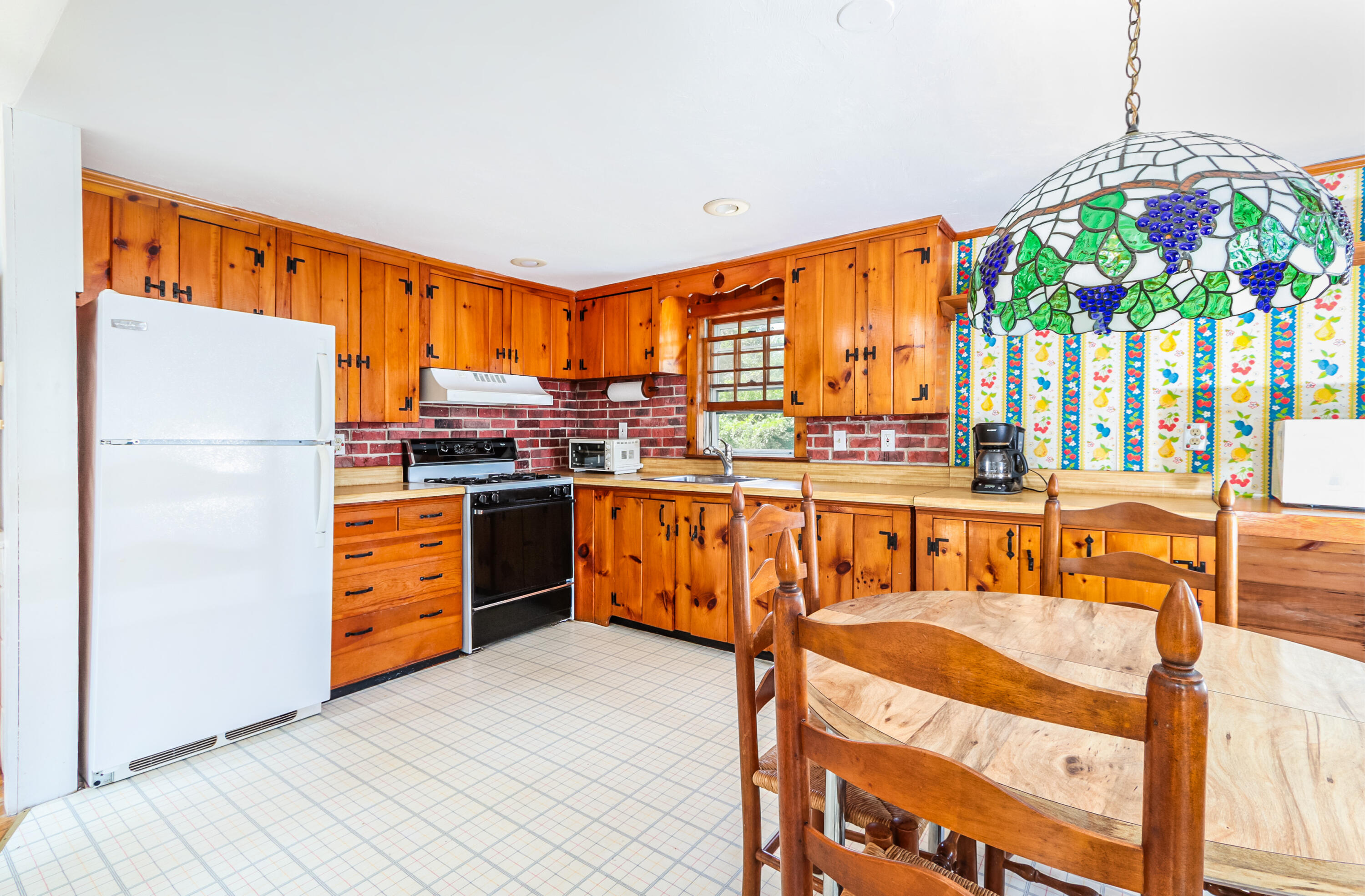 35 Susan Ruth Road Dennis Port, MA 02639 - Photo 8 of 23 a kitchen with stainless steel appliances granite countertop a stove a sink and a refrigerator