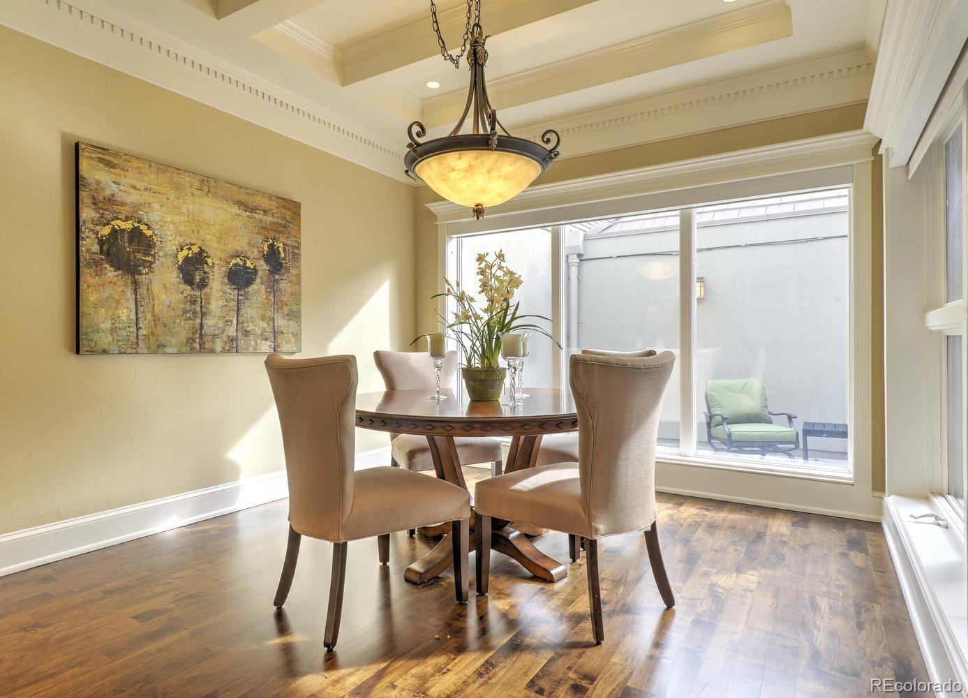 490 Columbine Street Denver, CO 80206 - Photo 16 of 33 a dining room with furniture a chandelier and wooden floor