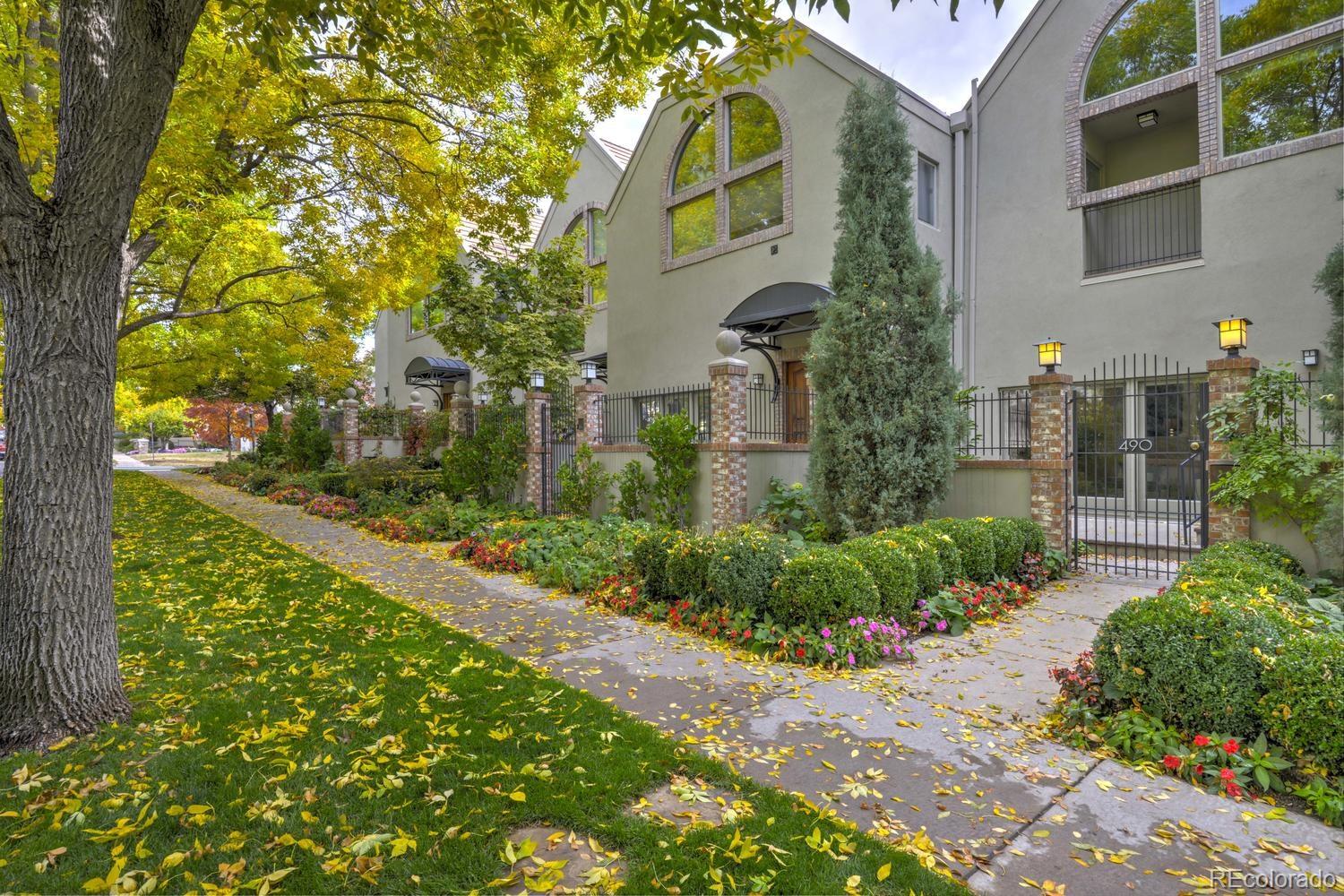 490 Columbine Street Denver, CO 80206 - Photo 2 of 33 a front view of a house with a yard and fountain