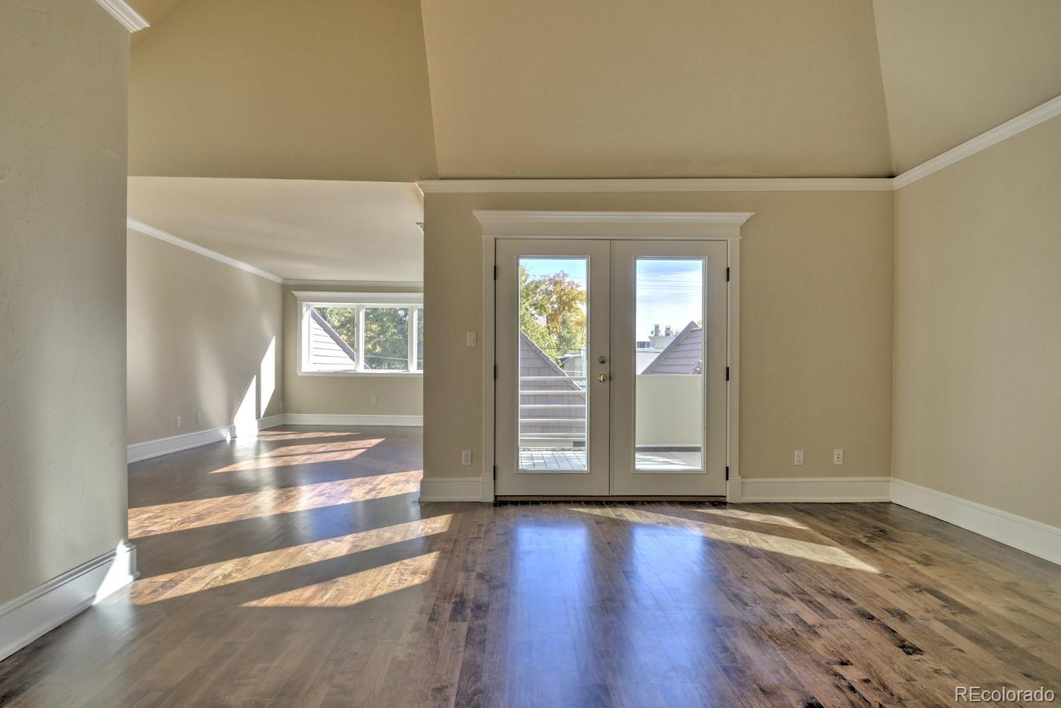 490 Columbine Street Denver, CO 80206 - Photo 21 of 33 an empty room with wooden floor and windows