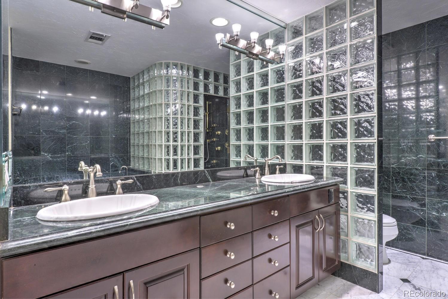 490 Columbine Street Denver, CO 80206 - Photo 24 of 33 a bathroom with a sink double vanity and a mirror