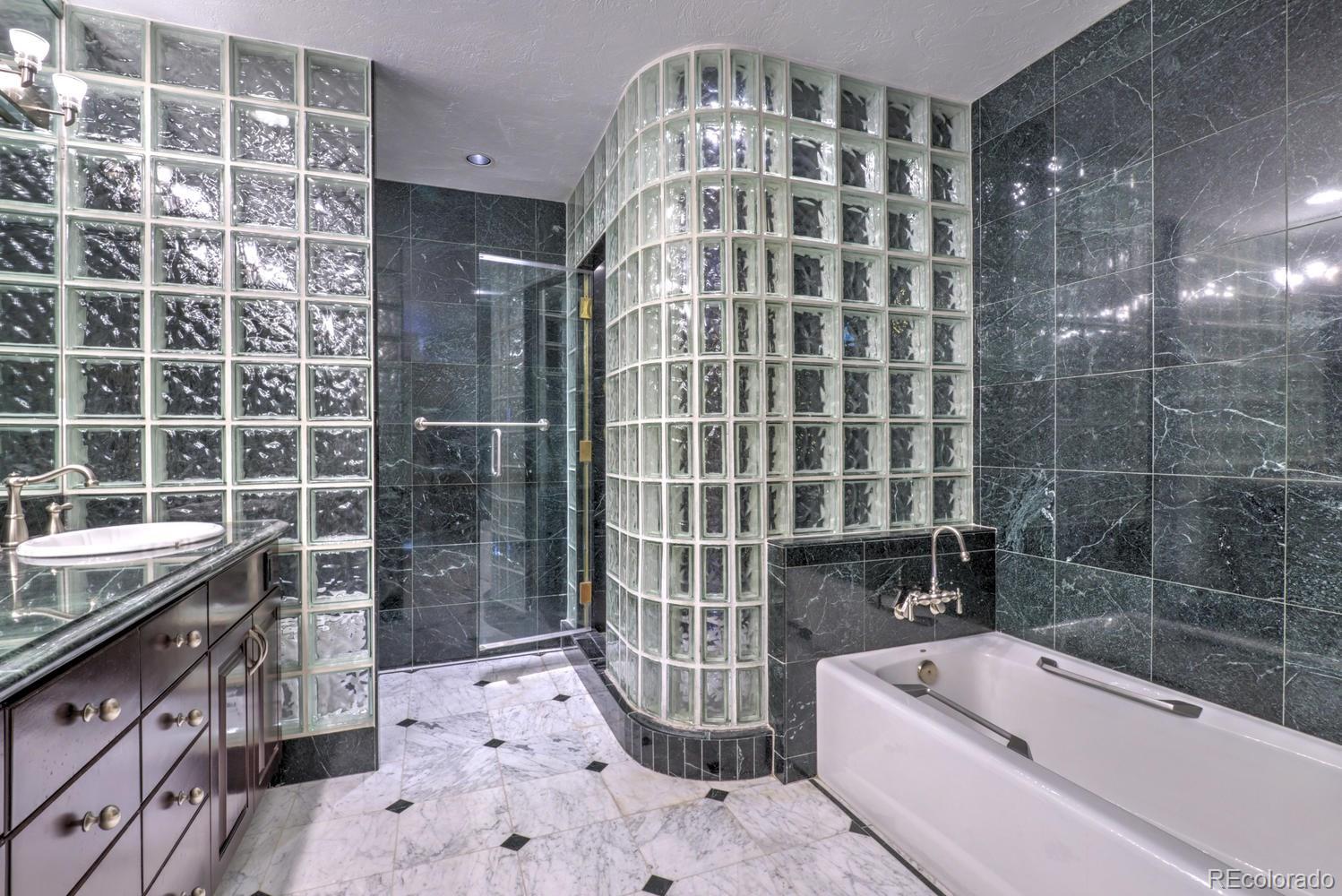 490 Columbine Street Denver, CO 80206 - Photo 25 of 33 a bathroom with a bathtub and a shower