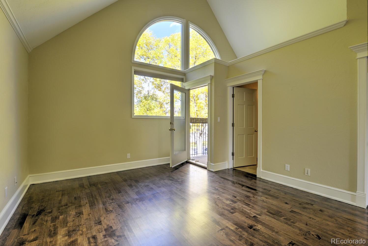 490 Columbine Street Denver, CO 80206 - Photo 26 of 33 an empty room with wooden floor and windows