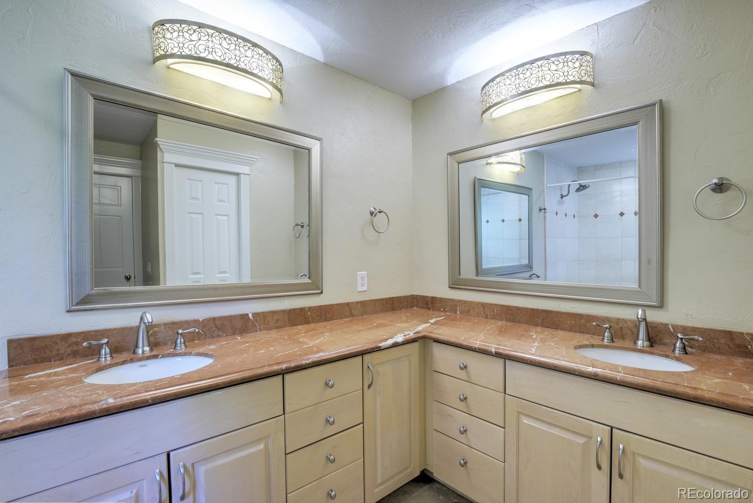 490 Columbine Street Denver, CO 80206 - Photo 28 of 33 a bathroom with double vanity sink and a mirror