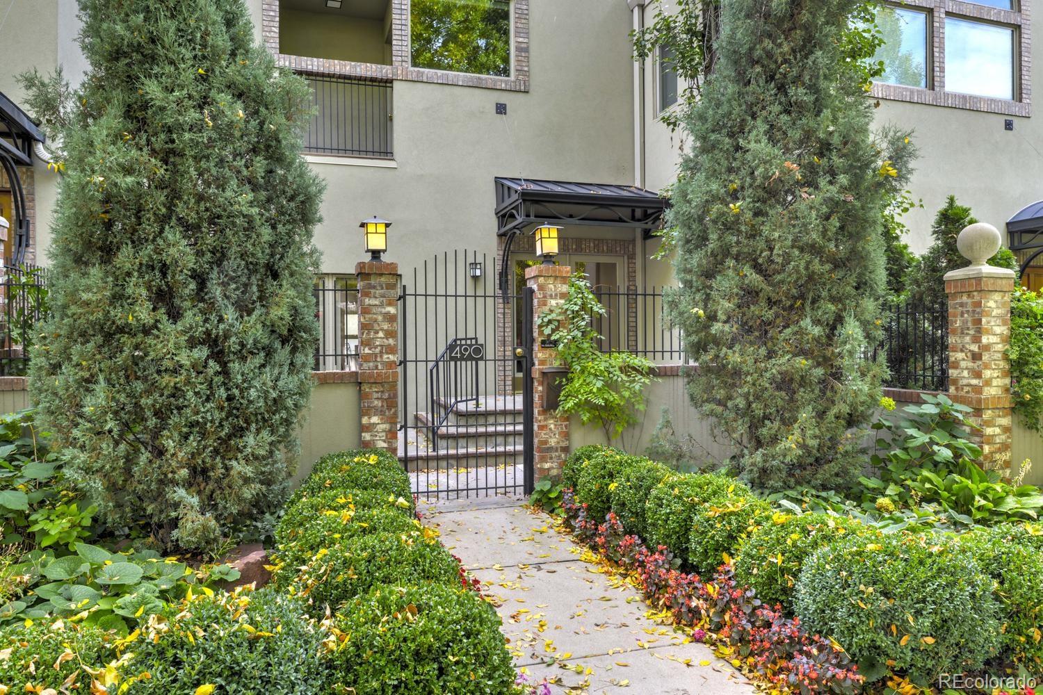 490 Columbine Street Denver, CO 80206 - Photo 4 of 33 a view of a pathway of a house with potted plants