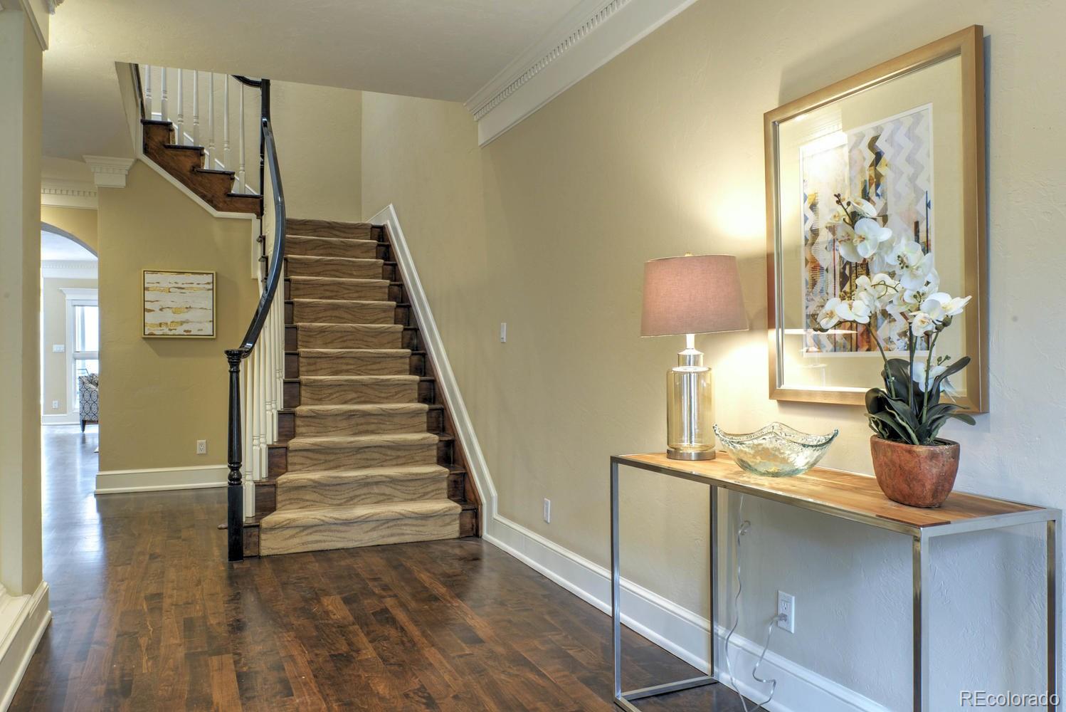 490 Columbine Street Denver, CO 80206 - Photo 7 of 33 a view of a room with wooden floor and stairs