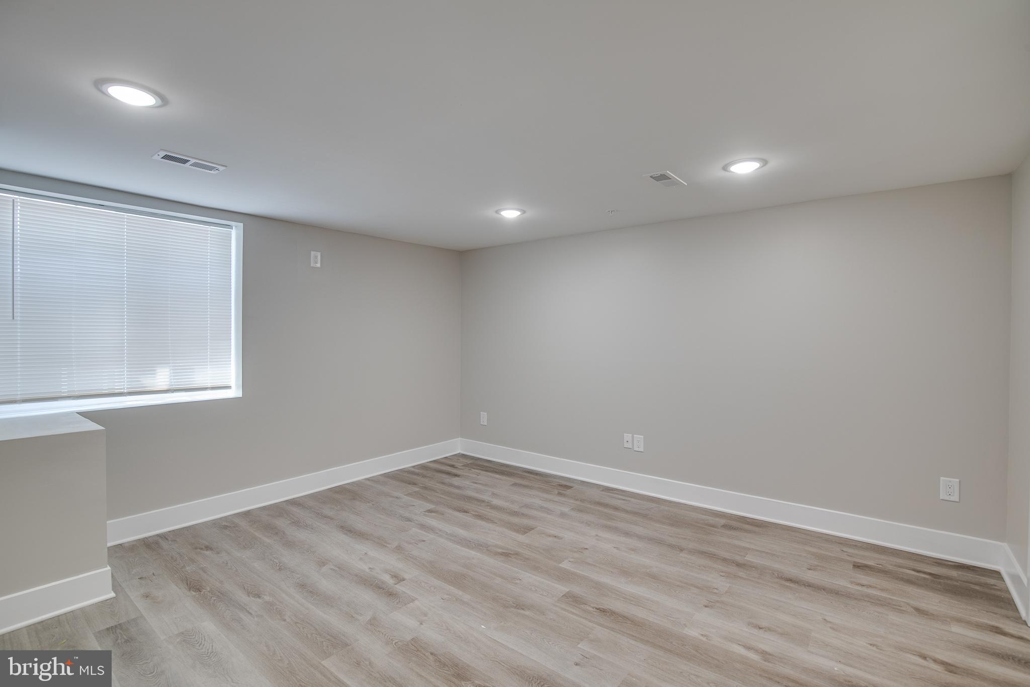 2017 North College Avenue, Unit 1 Philadelphia, PA 19121 - Photo 14 of 27 an empty room with wooden floor and windows