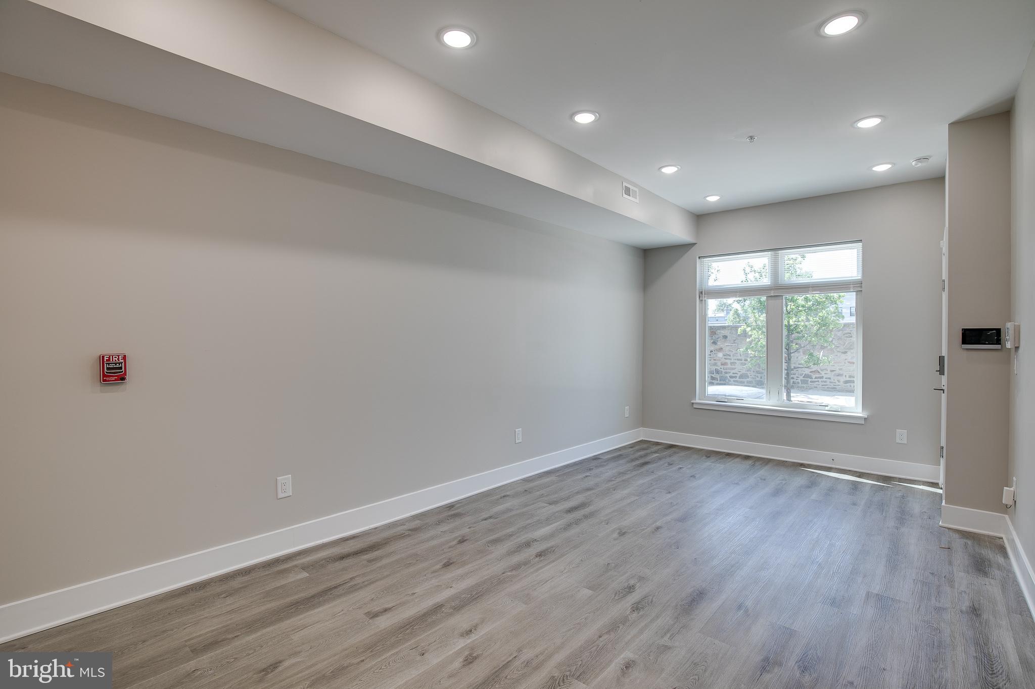 2017 North College Avenue, Unit 1 Philadelphia, PA 19121 - Photo 20 of 27 an empty room with wooden floor and windows