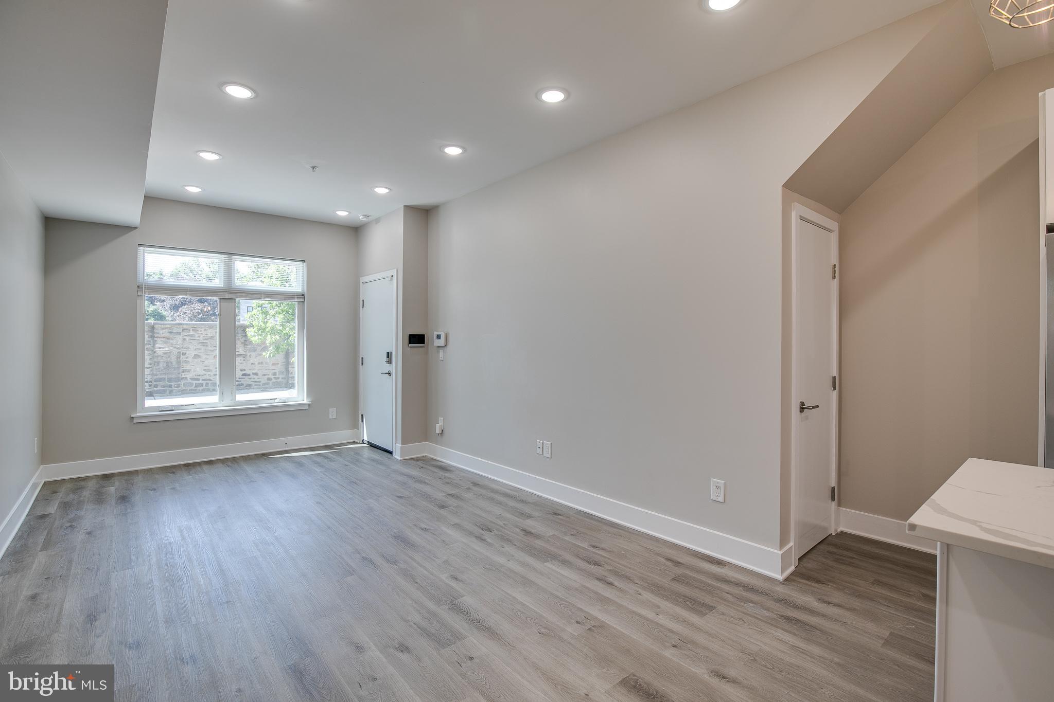 2017 North College Avenue, Unit 1 Philadelphia, PA 19121 - Photo 21 of 27 an empty room with wooden floor and window