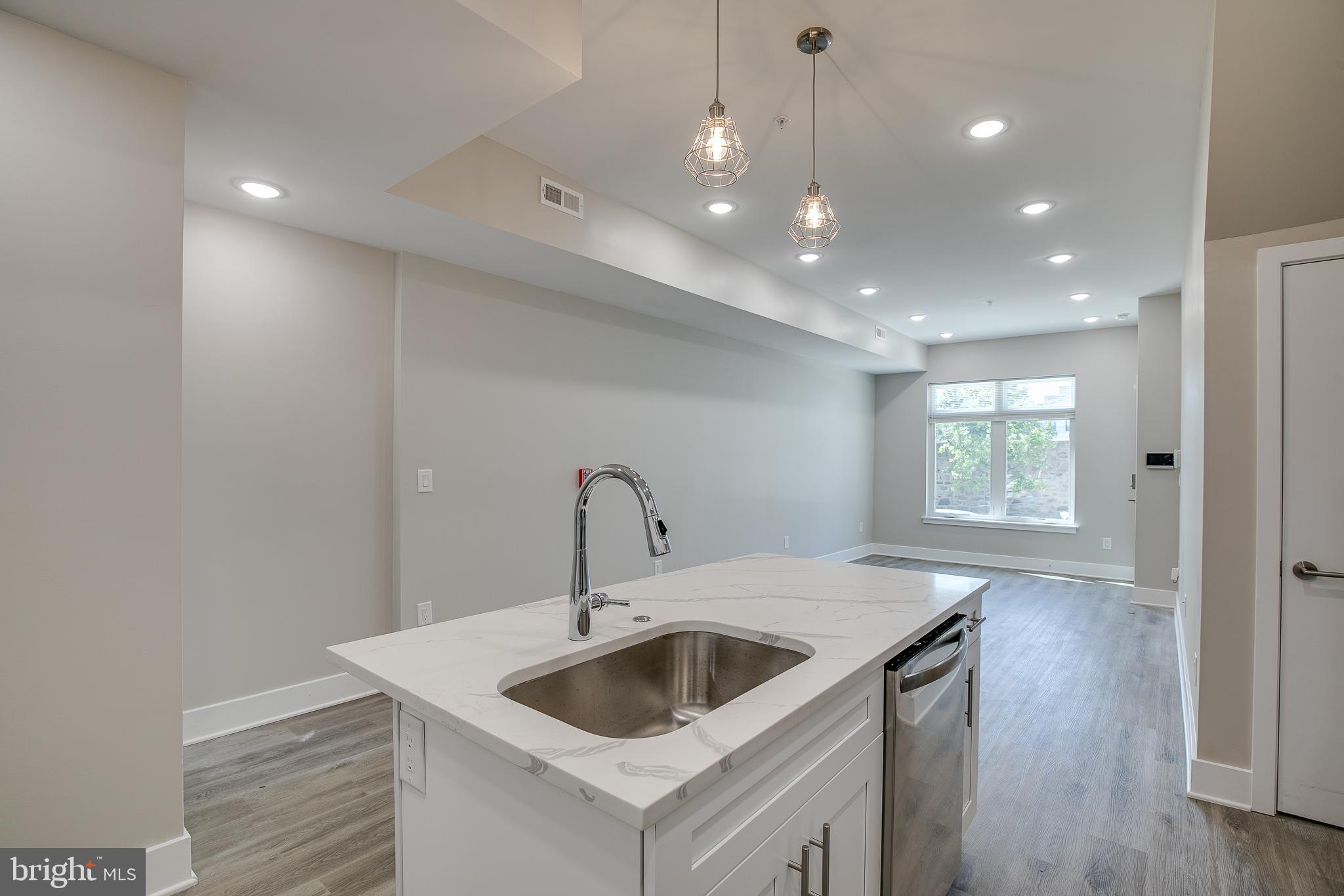 2017 North College Avenue, Unit 1 Philadelphia, PA 19121 - Photo 24 of 27 a kitchen with a sink a refrigerator and wooden floor