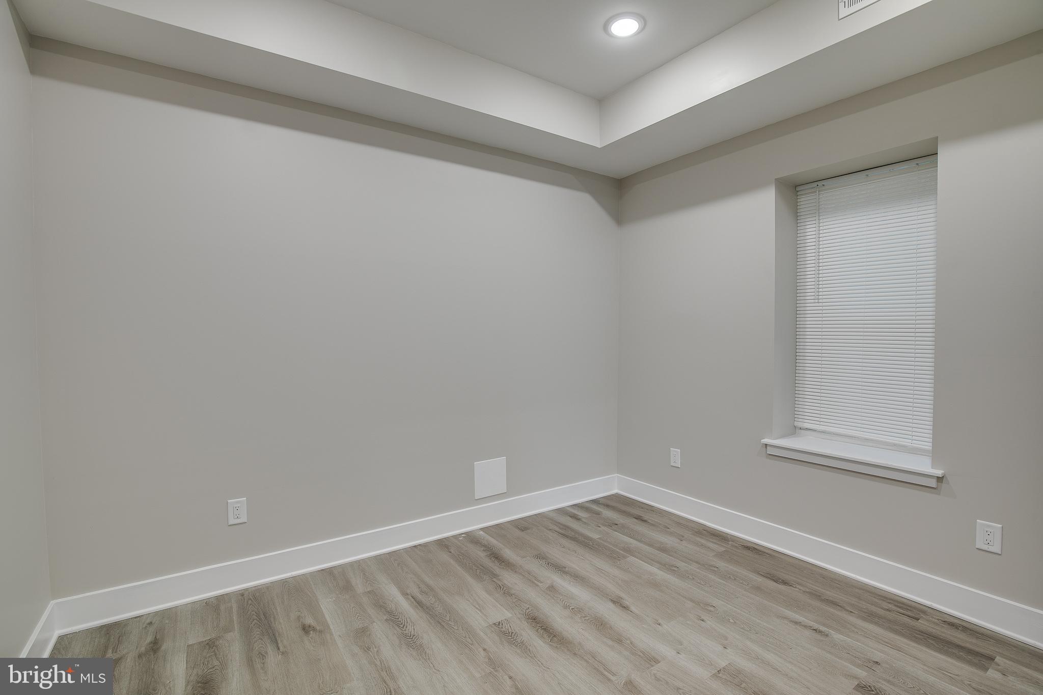 2017 North College Avenue, Unit 1 Philadelphia, PA 19121 - Photo 6 of 27 a view of an empty room with wooden floor and a window