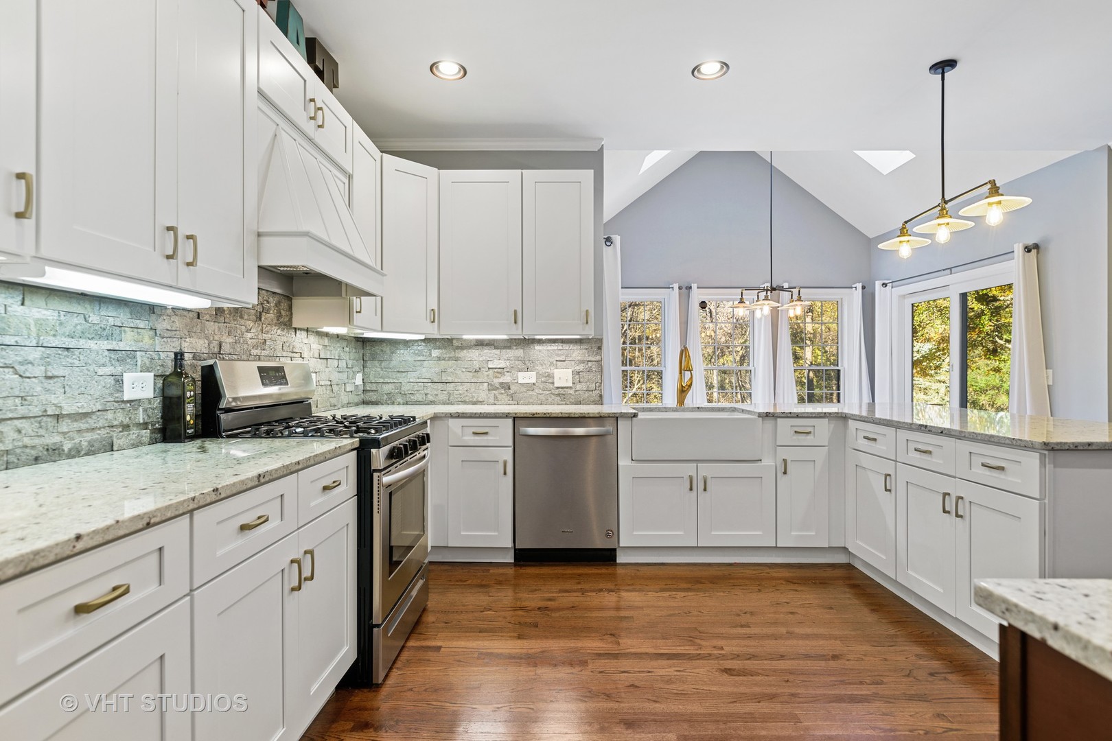 470 Long Hill Road Gurnee, IL 60031 - Photo 12 of 32 a kitchen with granite countertop white cabinets white appliances a sink and a window