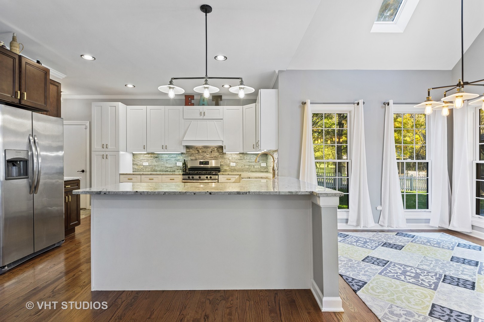 470 Long Hill Road Gurnee, IL 60031 - Photo 13 of 32 a kitchen with stainless steel appliances granite countertop a stove a sink dishwasher a refrigerator and white cabinets with wooden floor