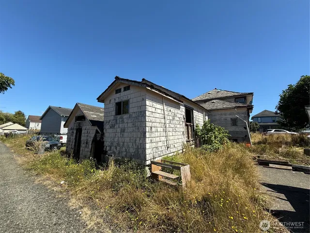 a backyard of a house with table and chairs