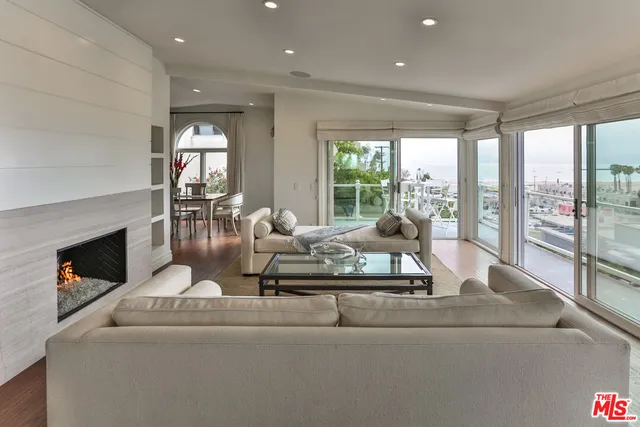 a front view of a house with garage and plants