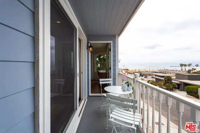 a spacious bedroom with a bed and glass window