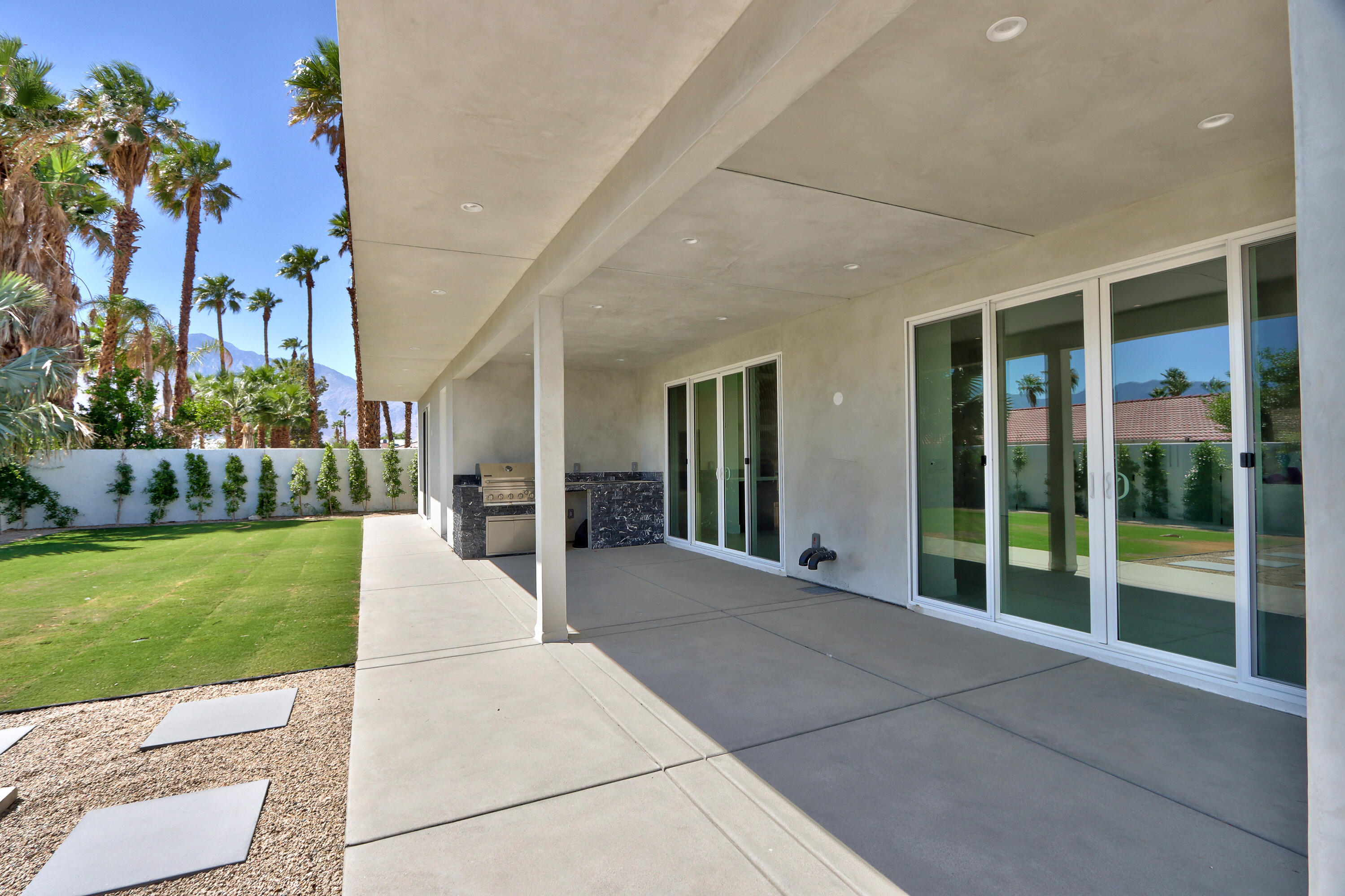 67385 Ovante Road Cathedral City, CA 92234 - Photo 24 of 32 a view of a house with a garden and pathway