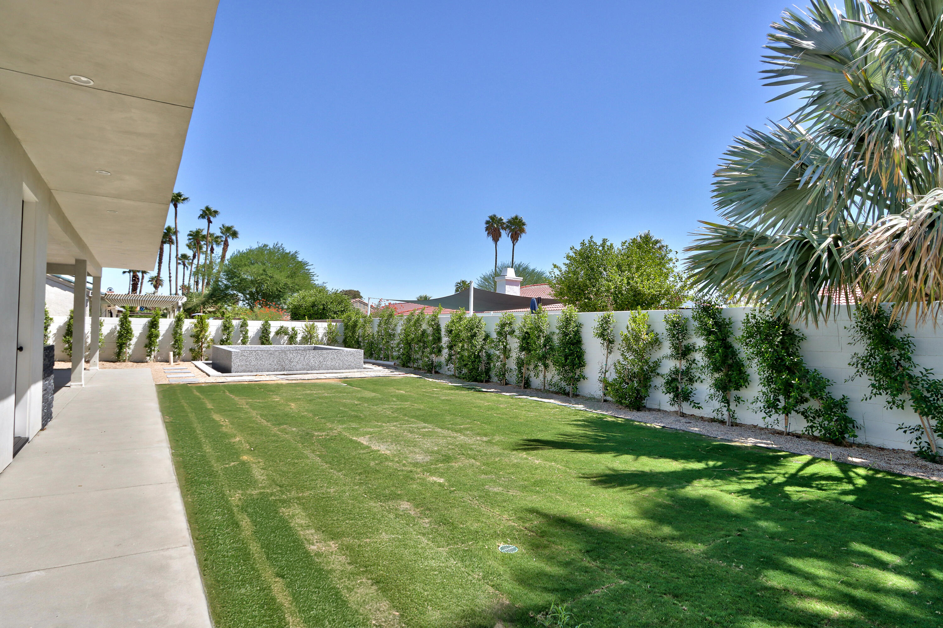 67385 Ovante Road Cathedral City, CA 92234 - Photo 27 of 32 a view of a swimming pool with a yard