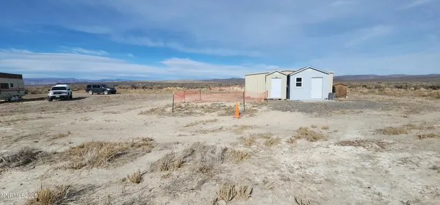 a view of a wooden door with a bench