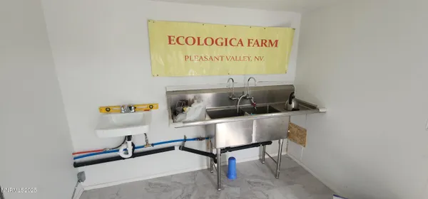 a view of a dirt road and building in the background