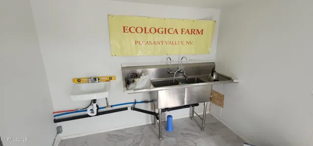 a view of a dirt road and building in the background