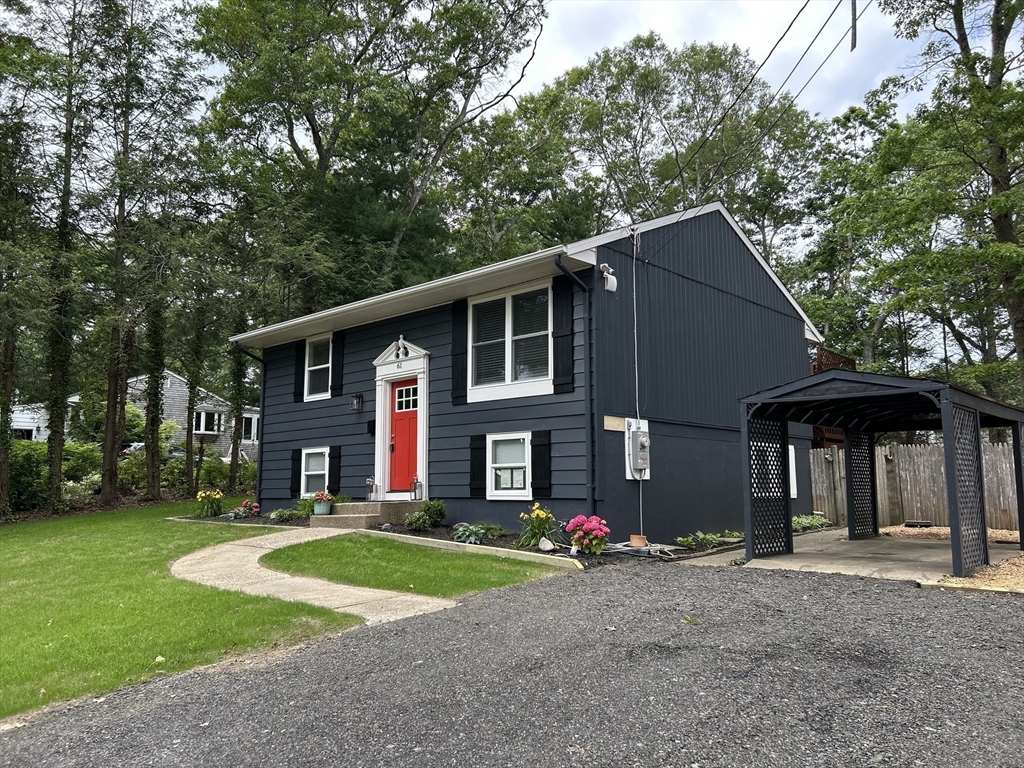61 Esta Road Plymouth, MA 02360 - Photo 3 of 40 a front view of a house with a yard and garage