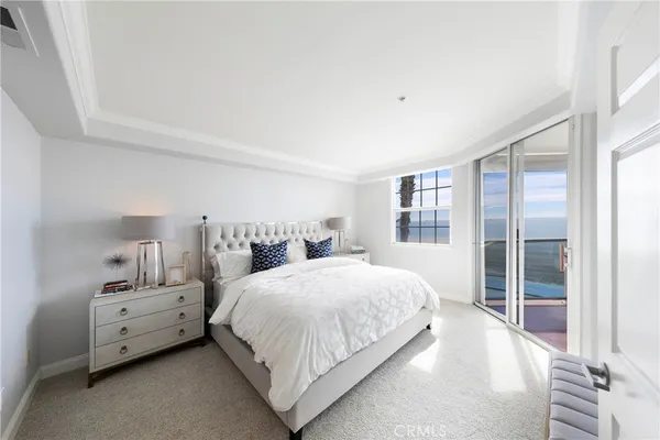 a bedroom with a bed and large window