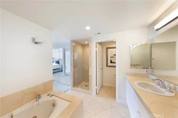 a bathroom with a tub sink and mirror