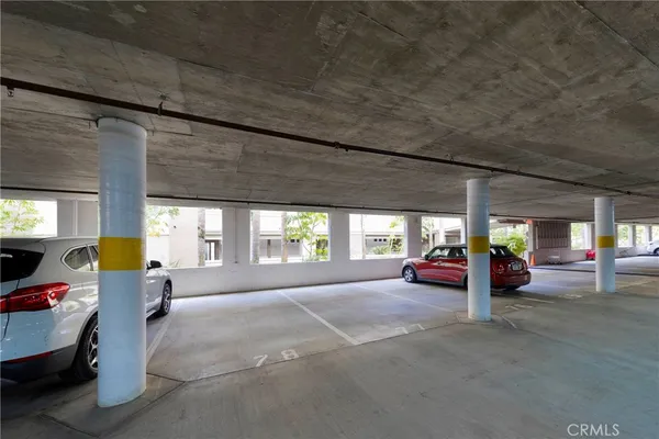 a view of a patio with table and chairs under an umbrella