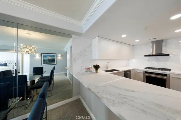 a large kitchen with stainless steel appliances kitchen island granite countertop a large stove a sink and a granite counter tops