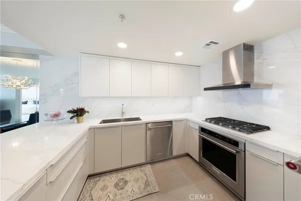 a kitchen with a sink stove top oven and cabinets