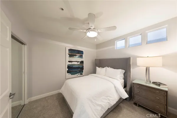 a bedroom with a bed and a ceiling fan