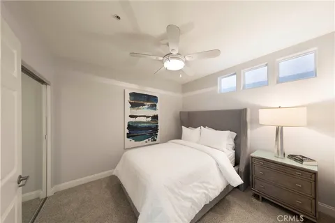 a bedroom with a bed and a ceiling fan