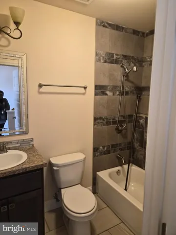 a white toilet sitting next to a bathroom sink