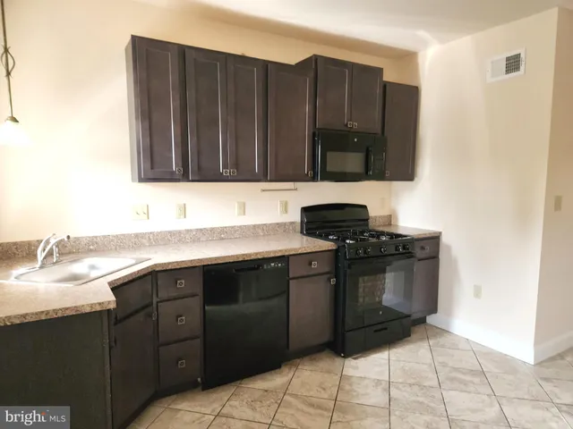a kitchen with a sink and a stove