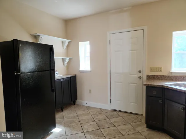 a kitchen with a refrigerator and a sink