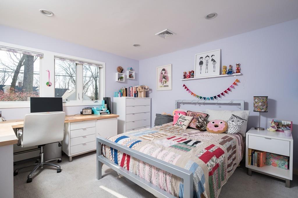 25 Rockwood Road Hingham, MA 02043 - Photo 23 of 34 a bedroom that has a bed and a table in it