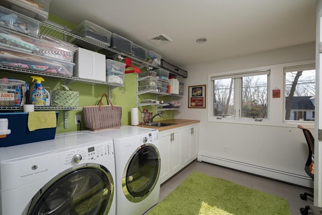 25 Rockwood Road Hingham, MA 02043 - Photo 27 of 34 a utility room with cabinets dryer and washer
