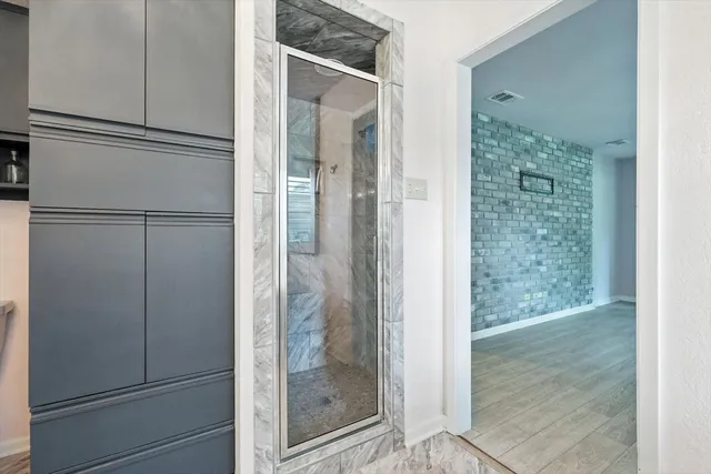 a bathroom with a glass shower door