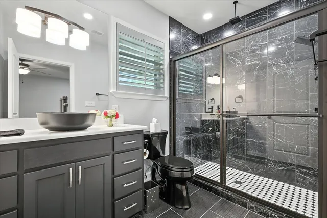 a bathroom with a shower sink and mirror
