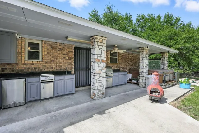 a view of a patio with table and chairs and potted plants